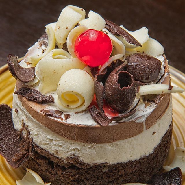 How about a white chocolate mousse and chocolate mousse with milk and white chocolate roses as toppings cake for this afternoon?