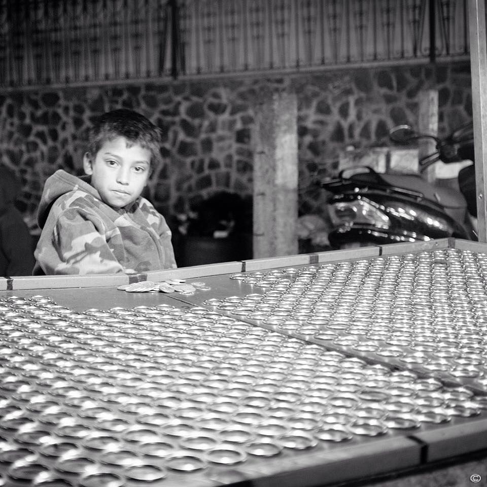 Street portrait of a kid working at the town fair of Ciudad Vieja, near Antigua Guatemala