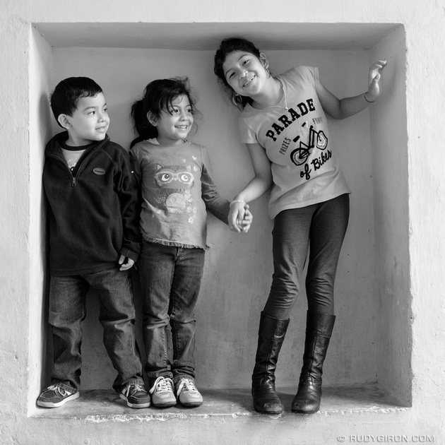 Street Photography — Three children framed within a niche