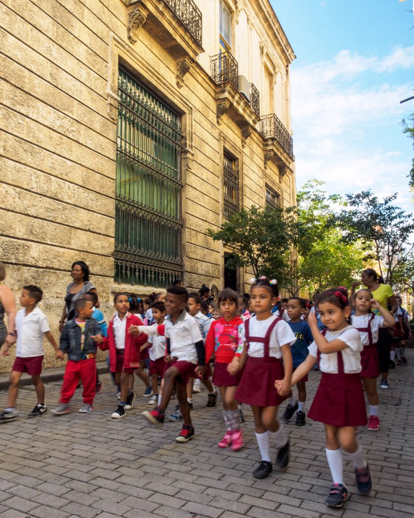 Quotidian Vista of La Habana Vieja: Primary school students marching through the streets BY RUDY GIRON