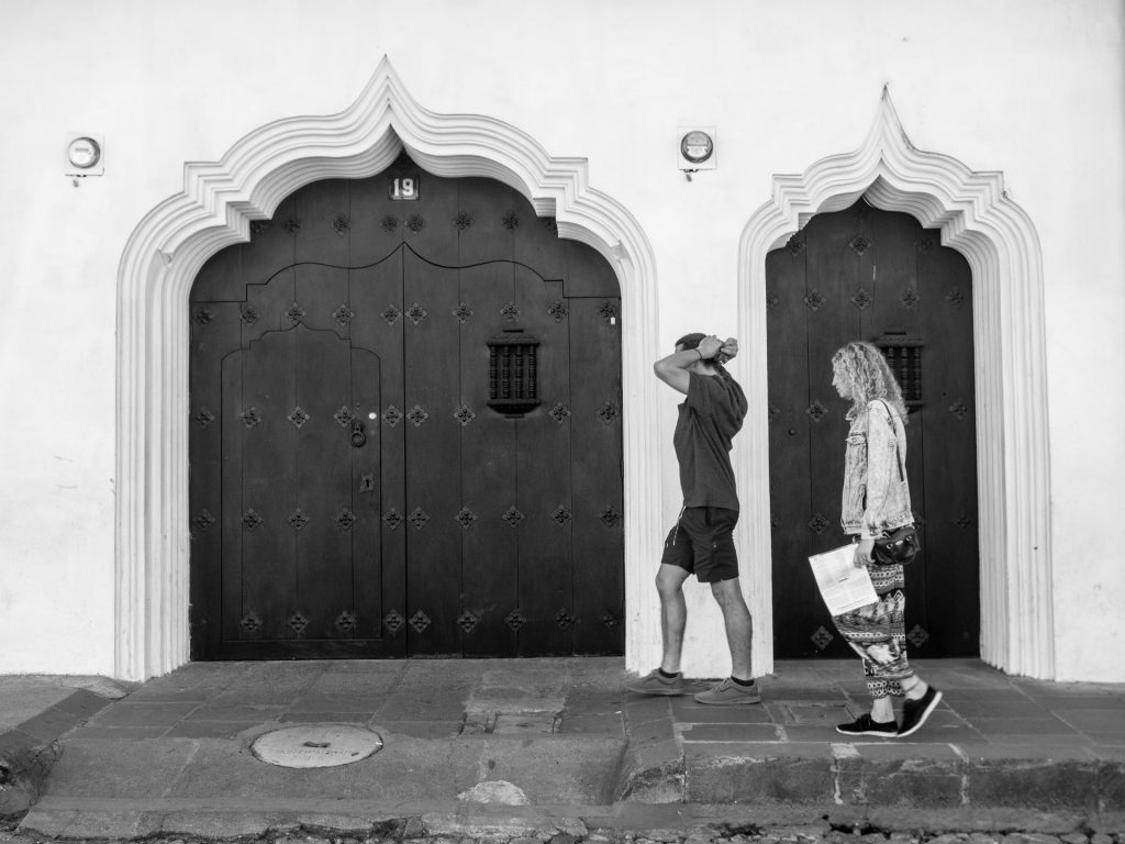 #StreetPhotography — Couple framed within two baroque Moorish doorways found in Antigua Guatemala